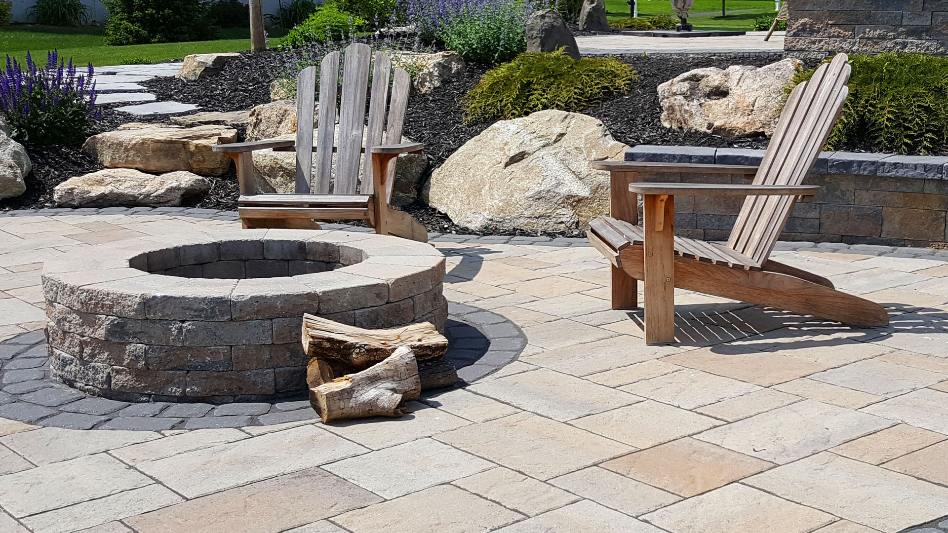 Close up of fire pit with Adirondack chairs