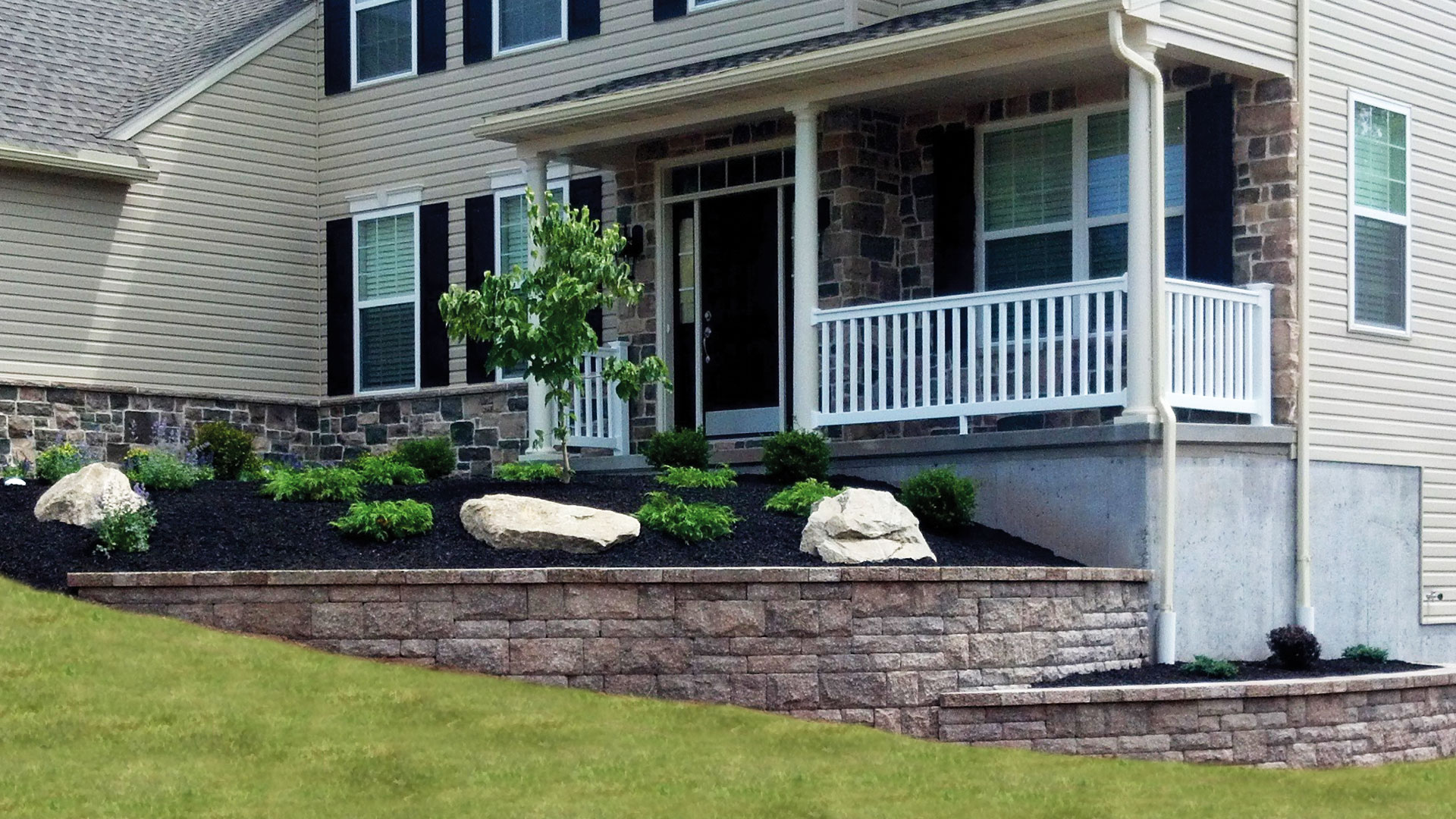 Planting with boulders, plants and retaining wall