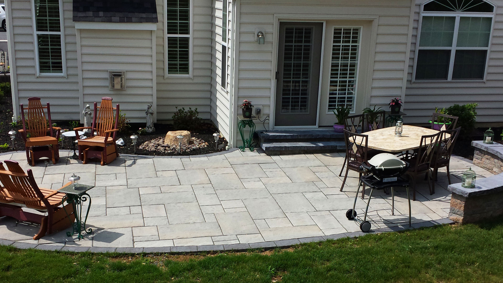 Paver patio with furnishings in backyard